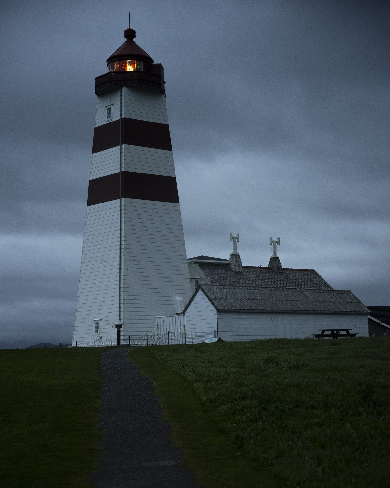 Striped lighthouse under a stormy sky